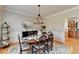 Elegant dining room with an oval wood table, seating for six, and a stylish chandelier at 5030 New Chapel Hill Way, Cumming, GA 30041