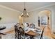 Beautiful dining room with wooden table, wainscotting, an elegant chandelier and hardwood flooring at 5030 New Chapel Hill Way, Cumming, GA 30041