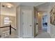 Bright hallway with staircase, neutral paint, and views into other rooms at 5030 New Chapel Hill Way, Cumming, GA 30041