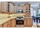 Well-lit kitchen showcasing wooden cabinetry, a stainless steel range, and an adjacent breakfast nook at 5030 New Chapel Hill Way, Cumming, GA 30041