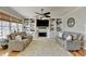 Bright living room featuring a ceiling fan, built-in shelving, fireplace, and comfortable sofas at 5030 New Chapel Hill Way, Cumming, GA 30041