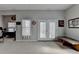 Spacious living room featuring double doors, window, bench and Packers decoration at 5030 New Chapel Hill Way, Cumming, GA 30041