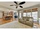 Living room with large windows and comfortable seating adjacent to an open kitchen area at 5030 New Chapel Hill Way, Cumming, GA 30041