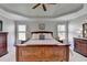 Primary bedroom with a tray ceiling, stylish furniture, and soft natural light at 5030 New Chapel Hill Way, Cumming, GA 30041