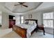 Primary bedroom featuring elegant furniture, a trey ceiling, and outdoor views at 5030 New Chapel Hill Way, Cumming, GA 30041