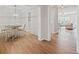 Dining area with chandelier, wood floors, and views of the living room at 5975 Vista Brook Dr, Suwanee, GA 30024