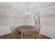 Formal dining room with wood table, chair rail detail, and elegant chandelier at 5975 Vista Brook Dr, Suwanee, GA 30024