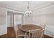 Dining room with tray ceiling, decorative chandelier, and wood table with seating at 5975 Vista Brook Dr, Suwanee, GA 30024