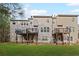 Rear view of townhomes highlighting wooden decks and expansive green lawn at 5975 Vista Brook Dr, Suwanee, GA 30024