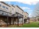 Townhome exteriors featuring private wooden decks and well-manicured lawn at 5975 Vista Brook Dr, Suwanee, GA 30024