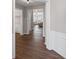 Hallway with dark wood floors, white trim, and an open view to the living room at 5975 Vista Brook Dr, Suwanee, GA 30024