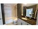 Well-lit bathroom with a shower-tub combo and a granite-topped vanity featuring modern fixtures at 855 Peachtree Ne St # 2309, Atlanta, GA 30308