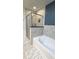 Bathroom featuring walk in shower, tub, and modern design elements at 855 Peachtree Ne St # 2309, Atlanta, GA 30308