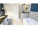 Bathroom featuring sleek glass shower, soaking tub, and modern design elements at 855 Peachtree Ne St # 2309, Atlanta, GA 30308