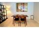 Modern dining area with a minimalist design, featuring a wooden table, stylish chairs, and contemporary artwork at 855 Peachtree Ne St # 2309, Atlanta, GA 30308