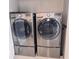 Efficient laundry setup with modern, front-loading LG washer and dryer set on pedestals at 855 Peachtree Ne St # 2309, Atlanta, GA 30308