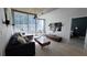 Open living room with modern furniture, a TV, and a sliding glass door that leads to a balcony at 855 Peachtree Ne St # 2309, Atlanta, GA 30308