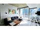 Living room with large windows, modern lighting, and comfortable sectional at 855 Peachtree Ne St # 2309, Atlanta, GA 30308