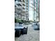 Charming outdoor patio with dining set, gas grill, and lush landscaping, perfect for entertaining at 855 Peachtree Ne St # 2309, Atlanta, GA 30308