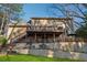 Exterior of the home features multi-level wooden decks and lush lawn at 1061 Steeple Run, Lawrenceville, GA 30043