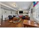 Finished basement living area with dark floors, neutral walls, comfortable seating and large screen TV at 1061 Steeple Run, Lawrenceville, GA 30043