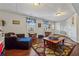Finished basement living area with dark floors, neutral walls, comfortable seating and colorful rug at 1061 Steeple Run, Lawrenceville, GA 30043