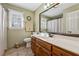 Stylish bathroom with a wood vanity, neutral walls, and a large mirror that enhances the room's aesthetic at 1061 Steeple Run, Lawrenceville, GA 30043