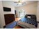 Cozy bedroom with wood floors, a comfortable bed, large window, and an accent rug at 1061 Steeple Run, Lawrenceville, GA 30043