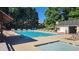 Community pool surrounded by lounge chairs and shade, perfect for relaxation and summer fun at 1061 Steeple Run, Lawrenceville, GA 30043