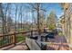 Enjoy outdoor living on this spacious deck with comfortable seating and views of the wooded backyard at 1061 Steeple Run, Lawrenceville, GA 30043