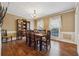 Spacious dining room with hardwood floors, crown molding, and a large window at 1061 Steeple Run, Lawrenceville, GA 30043