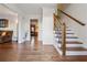 Elegant foyer features hardwood floors and a staircase with decorative iron railings at 1061 Steeple Run, Lawrenceville, GA 30043