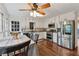 Eat-in kitchen with stainless steel appliances, white cabinets, and hardwood flooring at 1061 Steeple Run, Lawrenceville, GA 30043