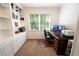 Bright office with built in shelves, a large window, and a comfortable desk with computer monitors at 1061 Steeple Run, Lawrenceville, GA 30043