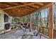 Spacious covered patio perfect for outdoor entertaining with ample seating and serene woodland views at 1061 Steeple Run, Lawrenceville, GA 30043