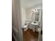 This powder room features a pedestal sink, wood-look floors, and attractive beadboard paneling at 1061 Steeple Run, Lawrenceville, GA 30043