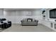 Finished basement with a comfortable gray sofa, dark leather recliner, and built-in entertainment center at 1431 Torrington Dr, Auburn, GA 30011