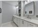 Bright bathroom featuring double vanity sinks, white cabinetry, granite countertops, and modern fixtures at 1431 Torrington Dr, Auburn, GA 30011