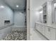 Bright bathroom with accessible zero entry shower, tiled walls, pebble floor, and a double vanity at 1431 Torrington Dr, Auburn, GA 30011