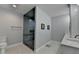 Modern bathroom featuring an accessible zero entry shower, tiled walls, and double vanity sinks at 1431 Torrington Dr, Auburn, GA 30011