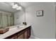 Bathroom featuring single vanity with a large mirror and decorative art adding a personal touch at 1431 Torrington Dr, Auburn, GA 30011