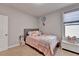Cozy bedroom with a gray headboard, pink bedding, and a whimsical moon and star wall decor at 1431 Torrington Dr, Auburn, GA 30011
