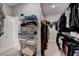Walk-in closet with ample shelving and hanging space for organized storage and convenience at 1431 Torrington Dr, Auburn, GA 30011