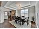 Bright dining room with a modern chandelier, wainscoting, and a view of the living room at 1431 Torrington Dr, Auburn, GA 30011
