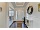 Inviting foyer with hardwood floors, elegant console table, decorative mirror, and recessed lighting at 1431 Torrington Dr, Auburn, GA 30011