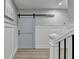 Stylish hallway featuring wainscoting and a light blue barn door, adding character to the space at 1431 Torrington Dr, Auburn, GA 30011