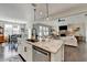 Kitchen island with stone countertop, sink, dishwasher, with open floor plan to living room and breakfast nook at 1431 Torrington Dr, Auburn, GA 30011