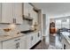 Modern kitchen with white cabinets, granite countertops, stainless steel appliances, and an adjacent dining area at 1431 Torrington Dr, Auburn, GA 30011