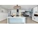 Stylish kitchen featuring white cabinets, stainless steel appliances, a central island, and modern lighting fixtures at 1431 Torrington Dr, Auburn, GA 30011