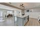 Open concept kitchen with a large island, white cabinets, and stainless steel appliances leading into the dining room at 1431 Torrington Dr, Auburn, GA 30011